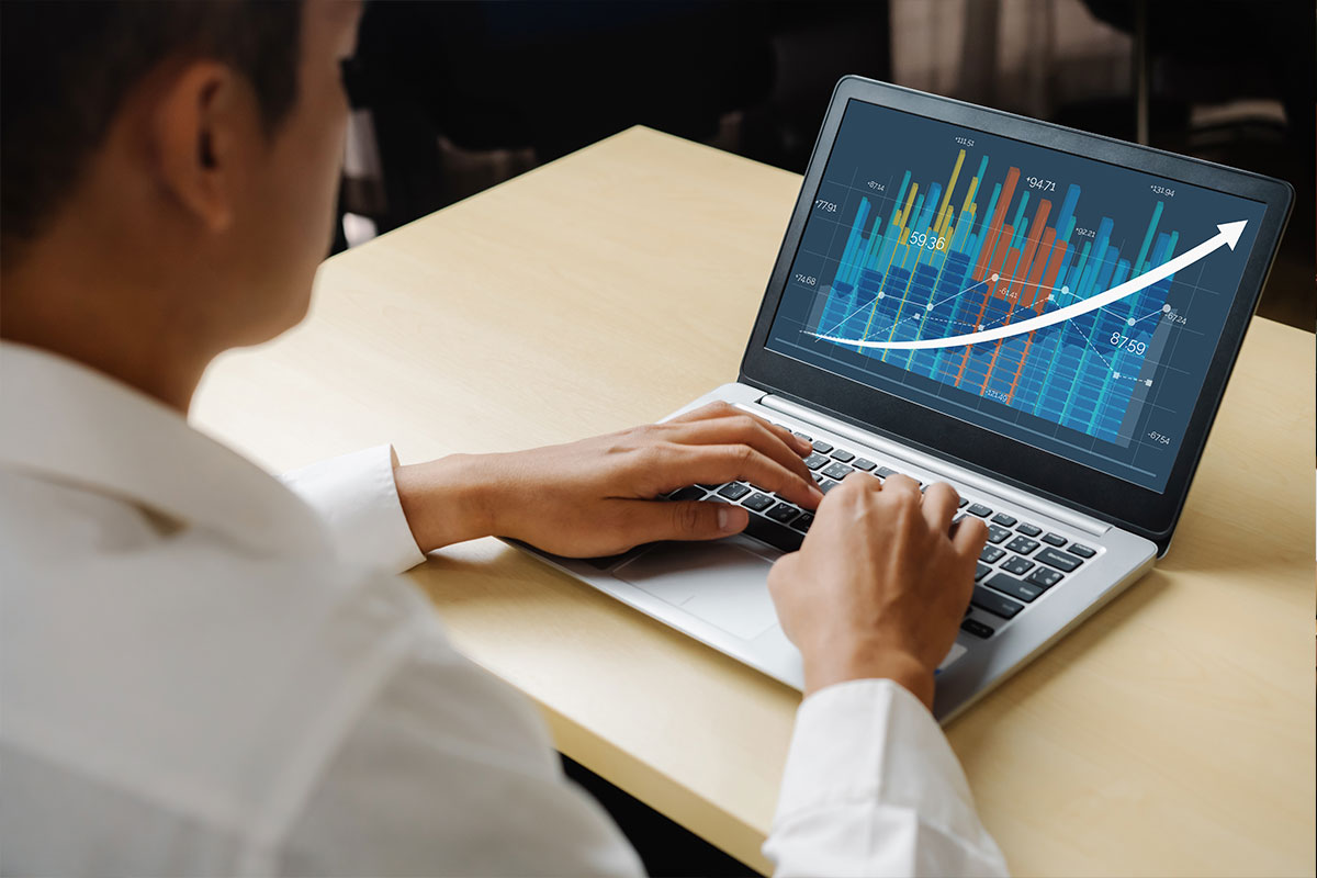 Man using computer with graphs