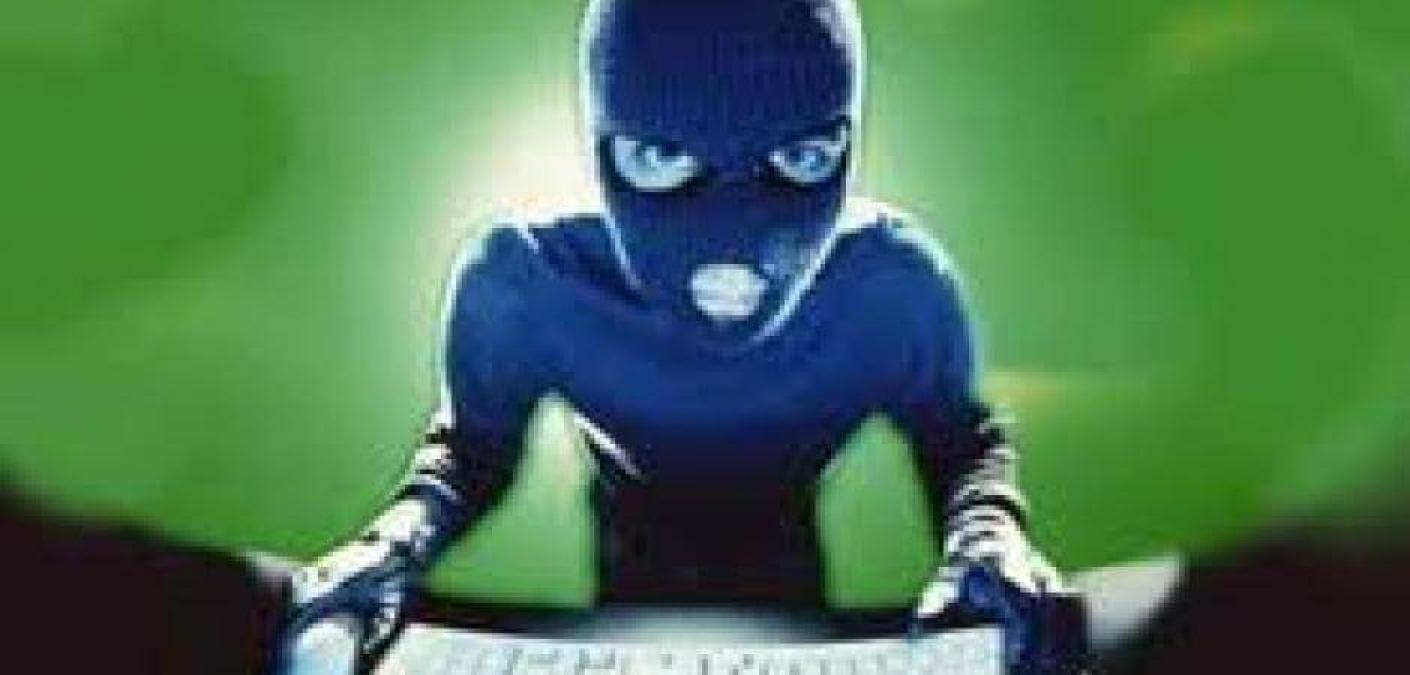 person in ski mask on computer