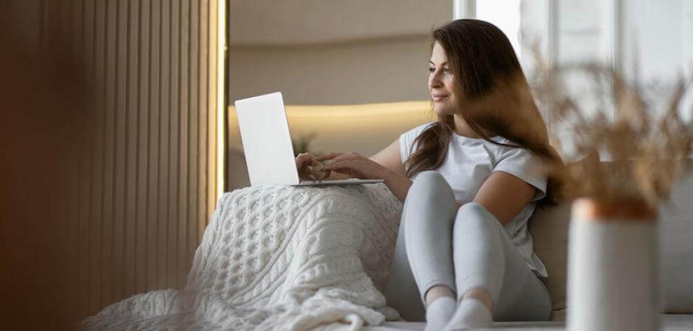 woman using computer on couch