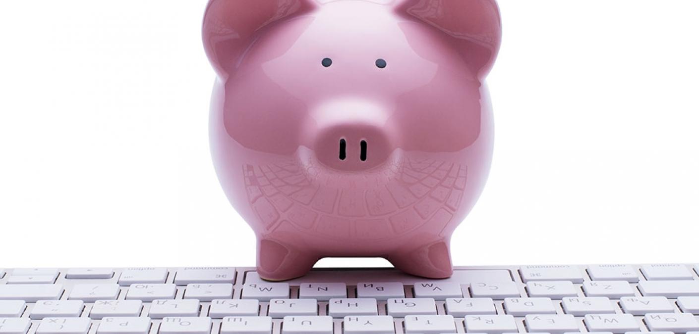 piggy bank next to a keyboard