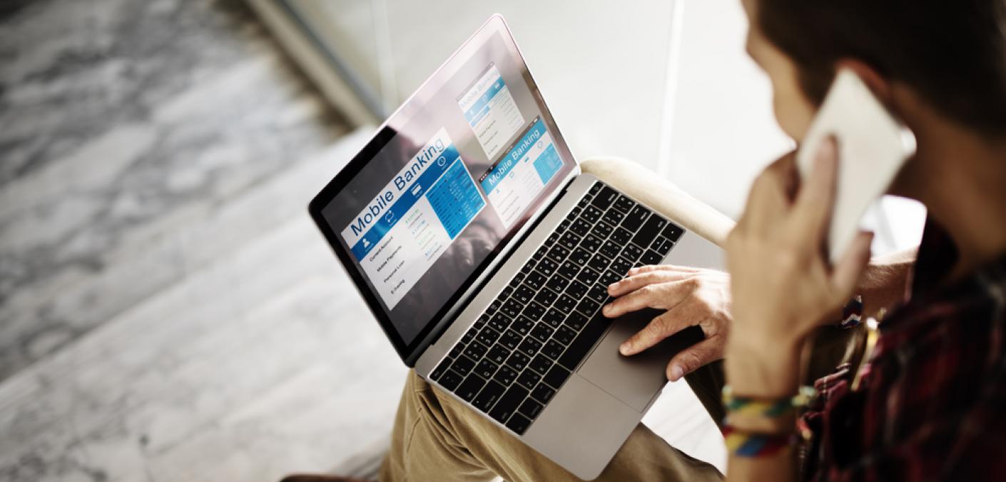 man on phone and laptop at the same time